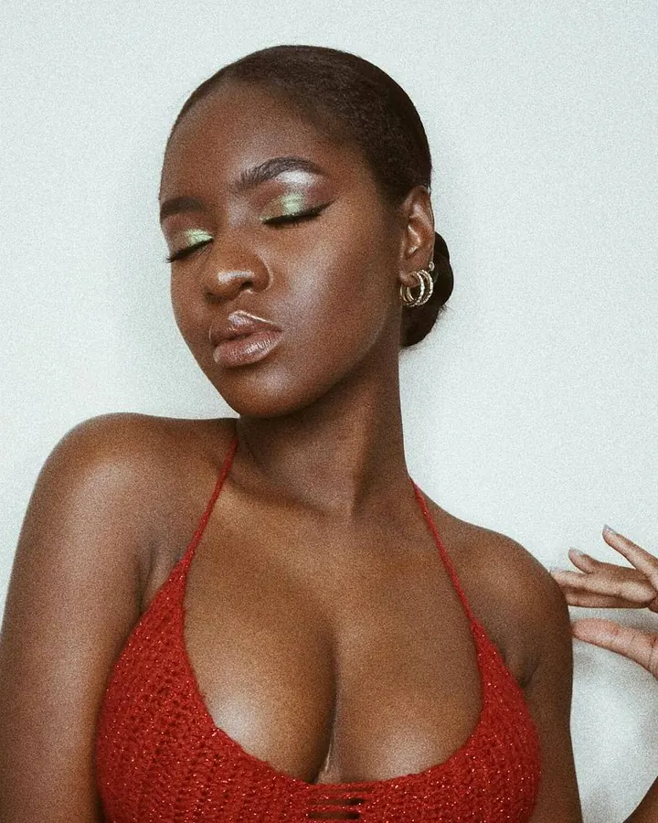 Femme africaine en lingerie noire, regardant l'appareil, cheveux longs